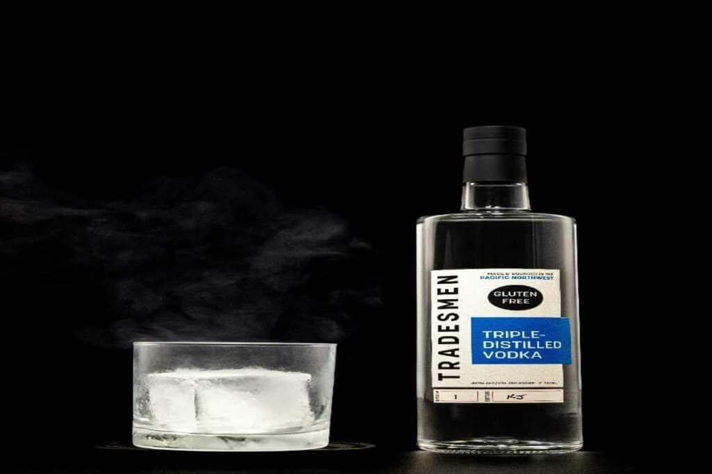 A bottle of alcohol next to a glass of ice Spotted Fox Digital